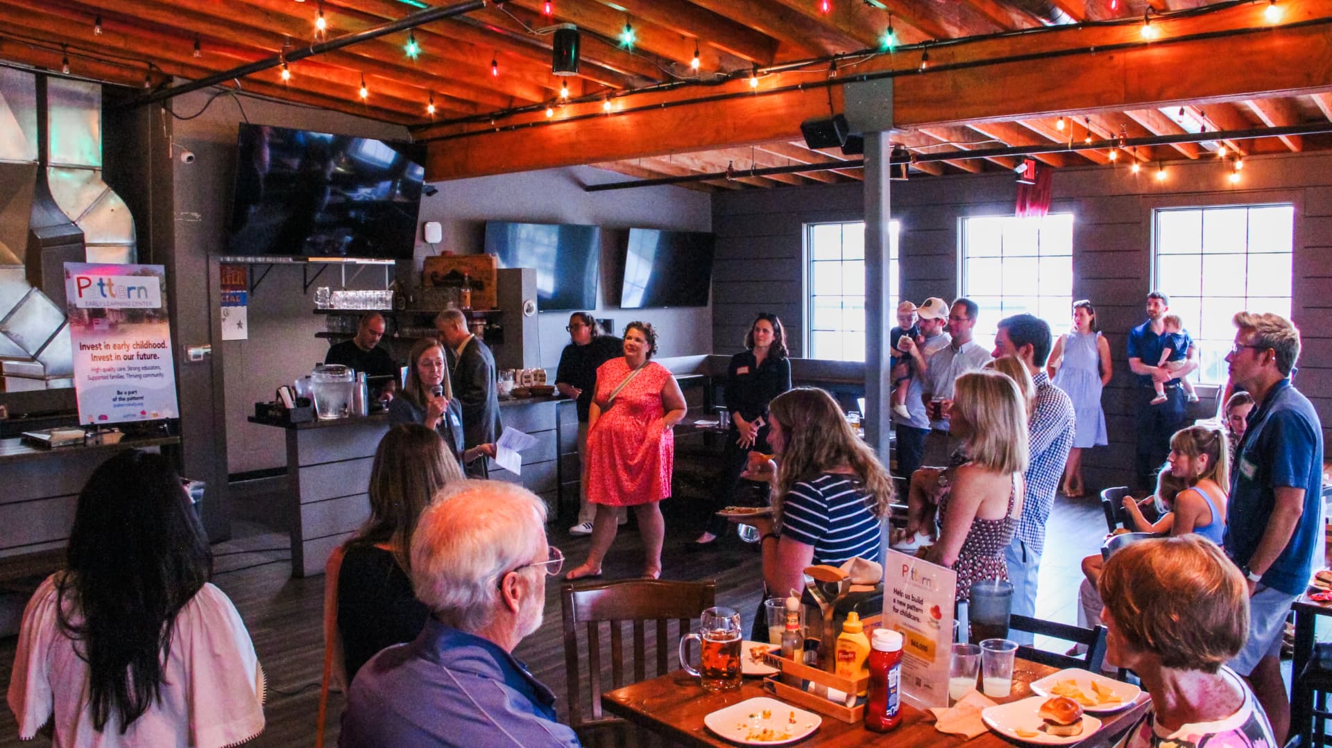 Guests gathered at Half Liter Brewery listening to a Patterns board member speak